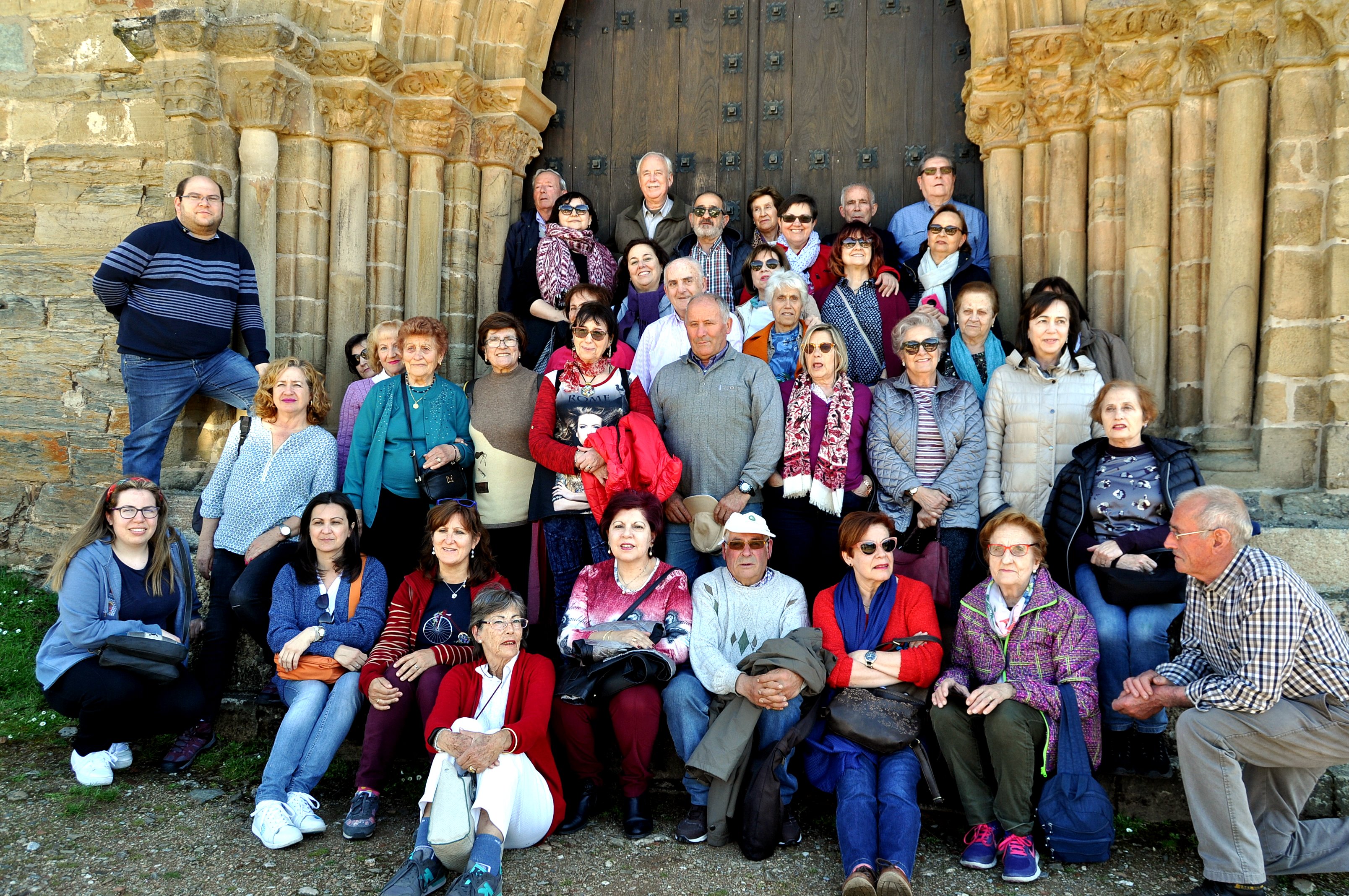 Grupo de peregrinos de Promonumenta ante la "Puerta del Perdón" de la iglesia de Santiago, en Villafranca.